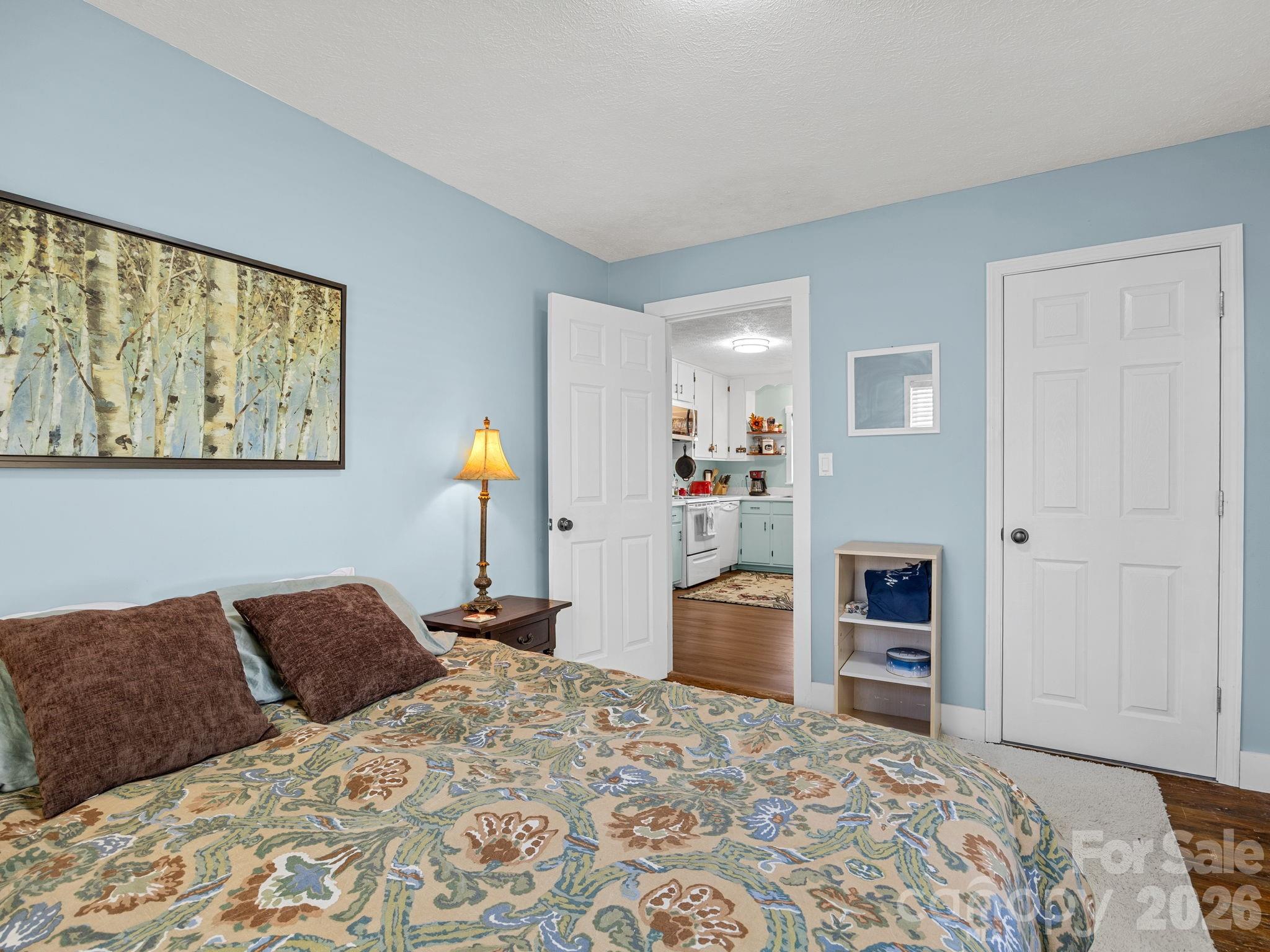 1434 Lake Adger Road Mill Spring, NC 28756 - Photo 25 of 47 a bedroom with a bed and a dresser