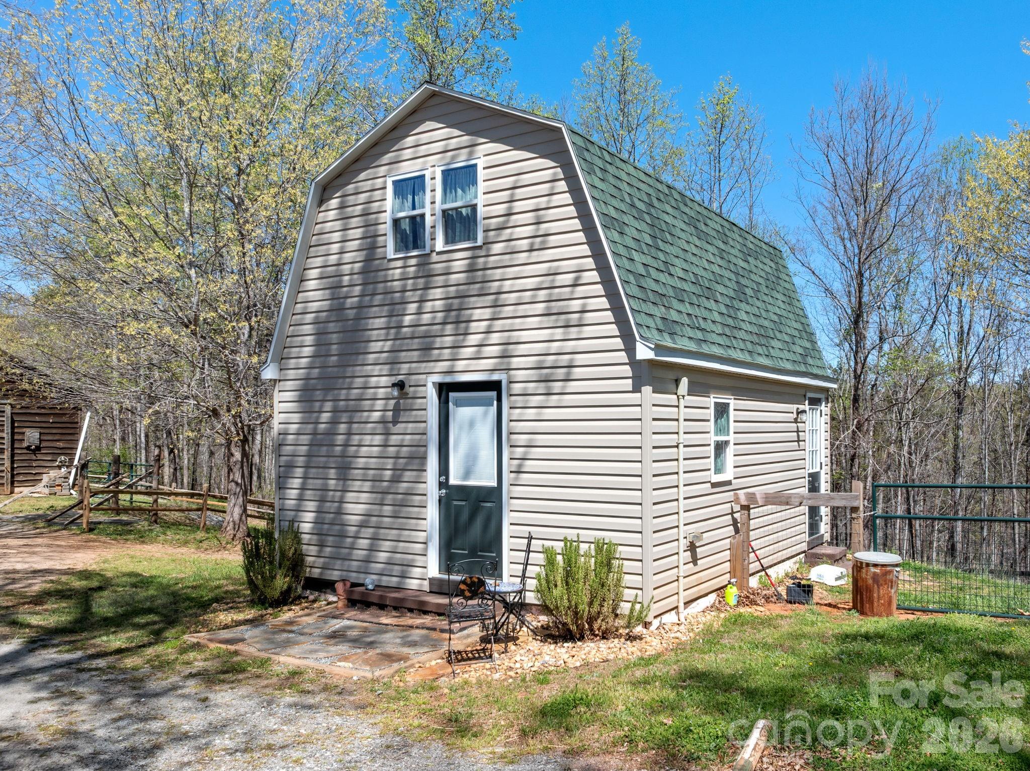 1434 Lake Adger Road Mill Spring, NC 28756 - Photo 27 of 47 a view of a house with backyard and a tree