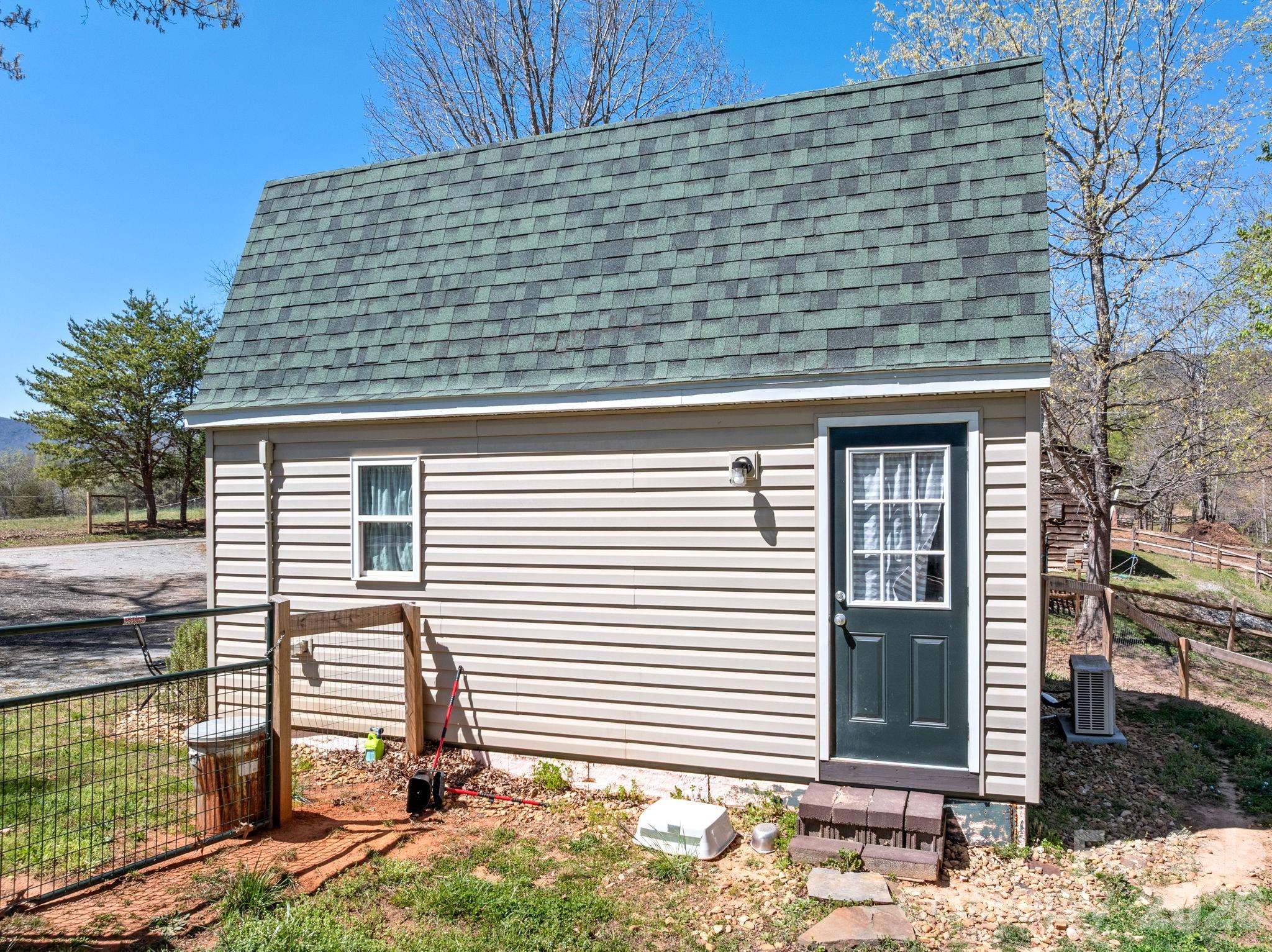 1434 Lake Adger Road Mill Spring, NC 28756 - Photo 28 of 47 a front view of a house with a garden