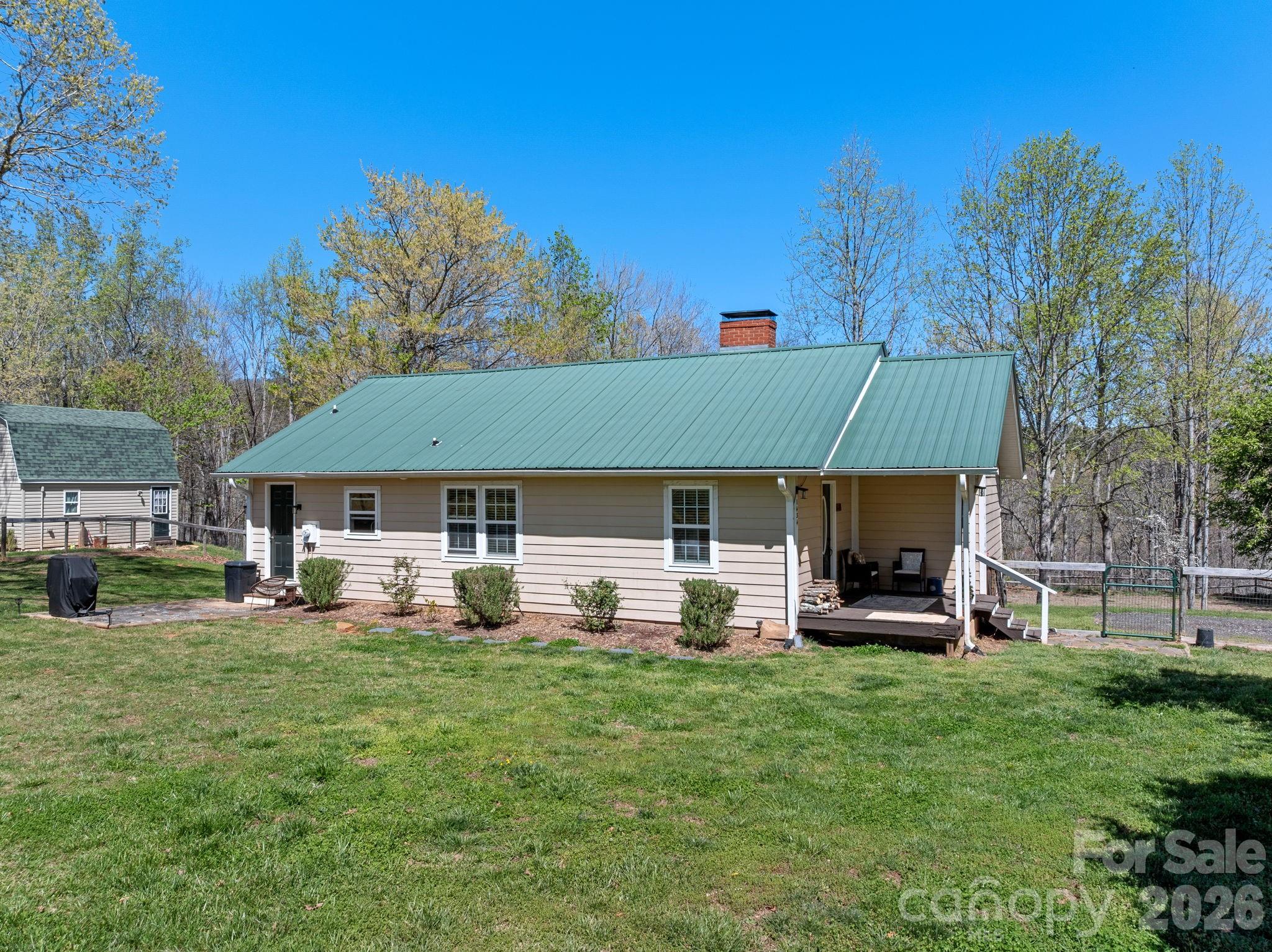 1434 Lake Adger Road Mill Spring, NC 28756 - Photo 3 of 47 a view of a house with backyard porch and sitting area