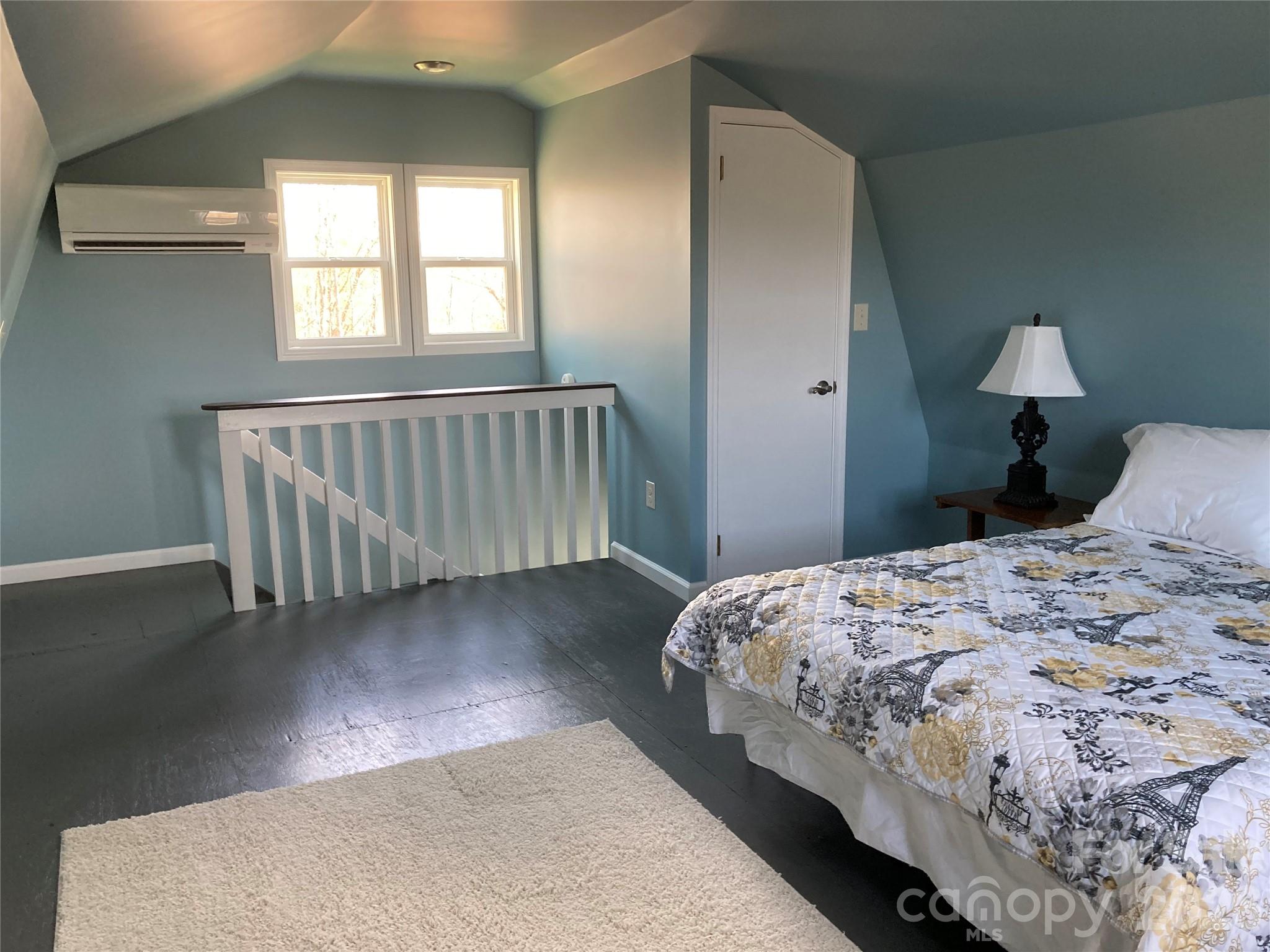 1434 Lake Adger Road Mill Spring, NC 28756 - Photo 32 of 47 a bedroom with a bed and a window