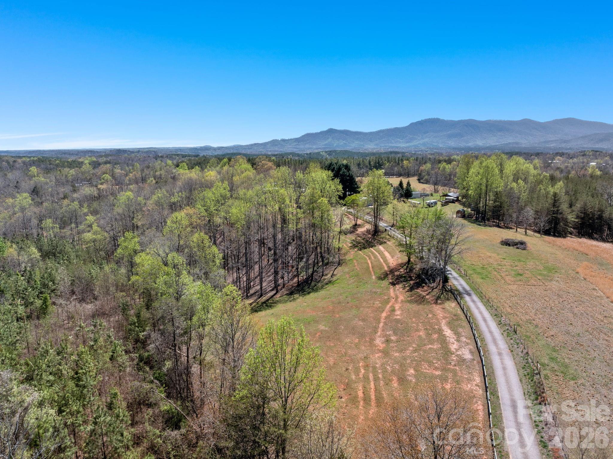 1434 Lake Adger Road Mill Spring, NC 28756 - Photo 41 of 47 a view of a lake with mountain