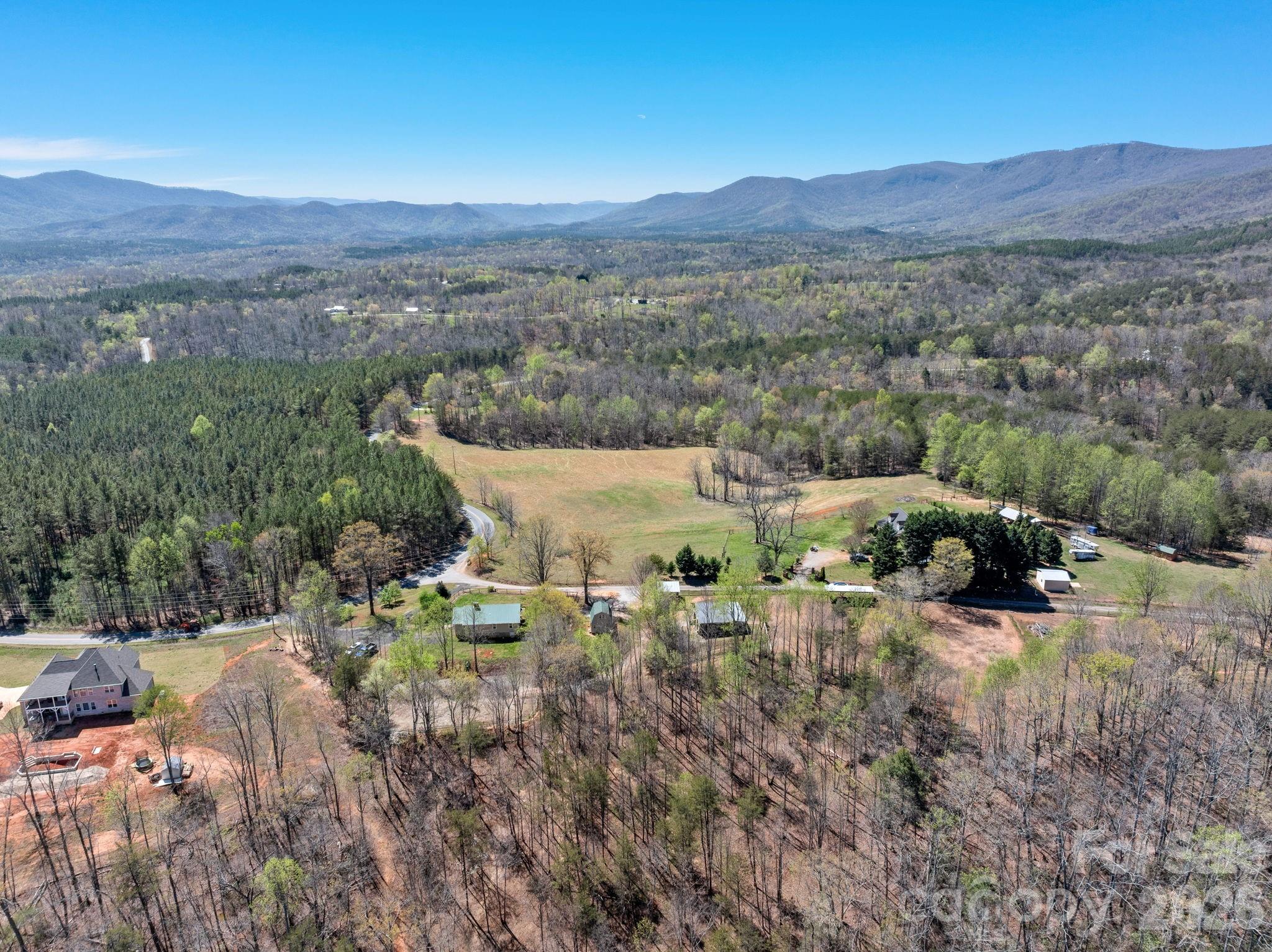 1434 Lake Adger Road Mill Spring, NC 28756 - Photo 46 of 47 a view of a lush green hillside and houses