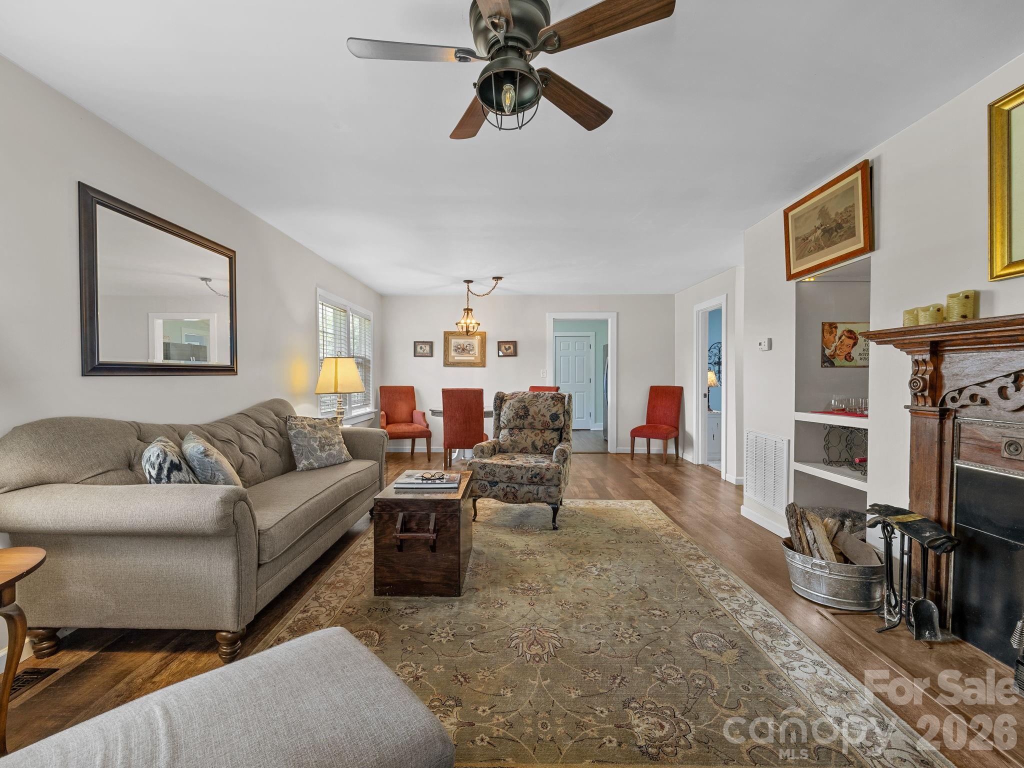 1434 Lake Adger Road Mill Spring, NC 28756 - Photo 7 of 47 a living room with furniture a flat screen tv and a fireplace