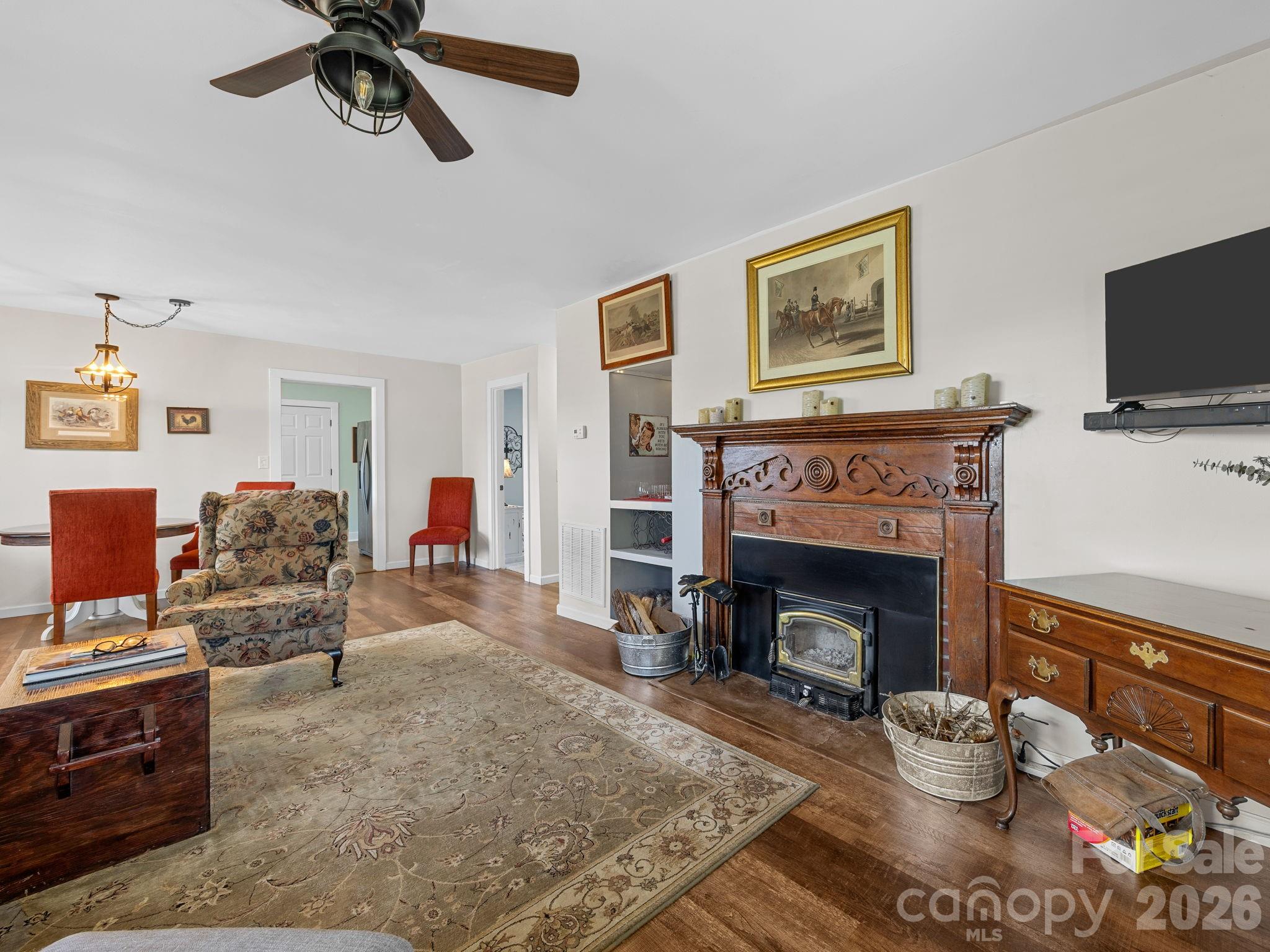 1434 Lake Adger Road Mill Spring, NC 28756 - Photo 8 of 47 a living room with furniture and a fireplace