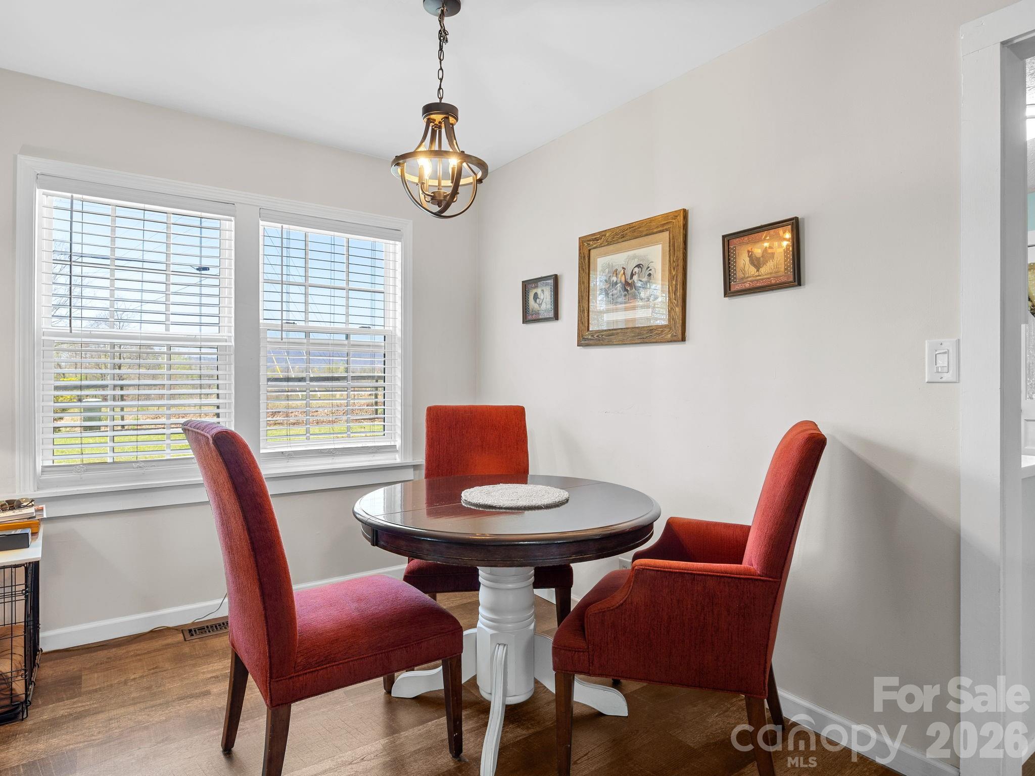 1434 Lake Adger Road Mill Spring, NC 28756 - Photo 10 of 47 a view of a dining room with furniture window and wooden floor