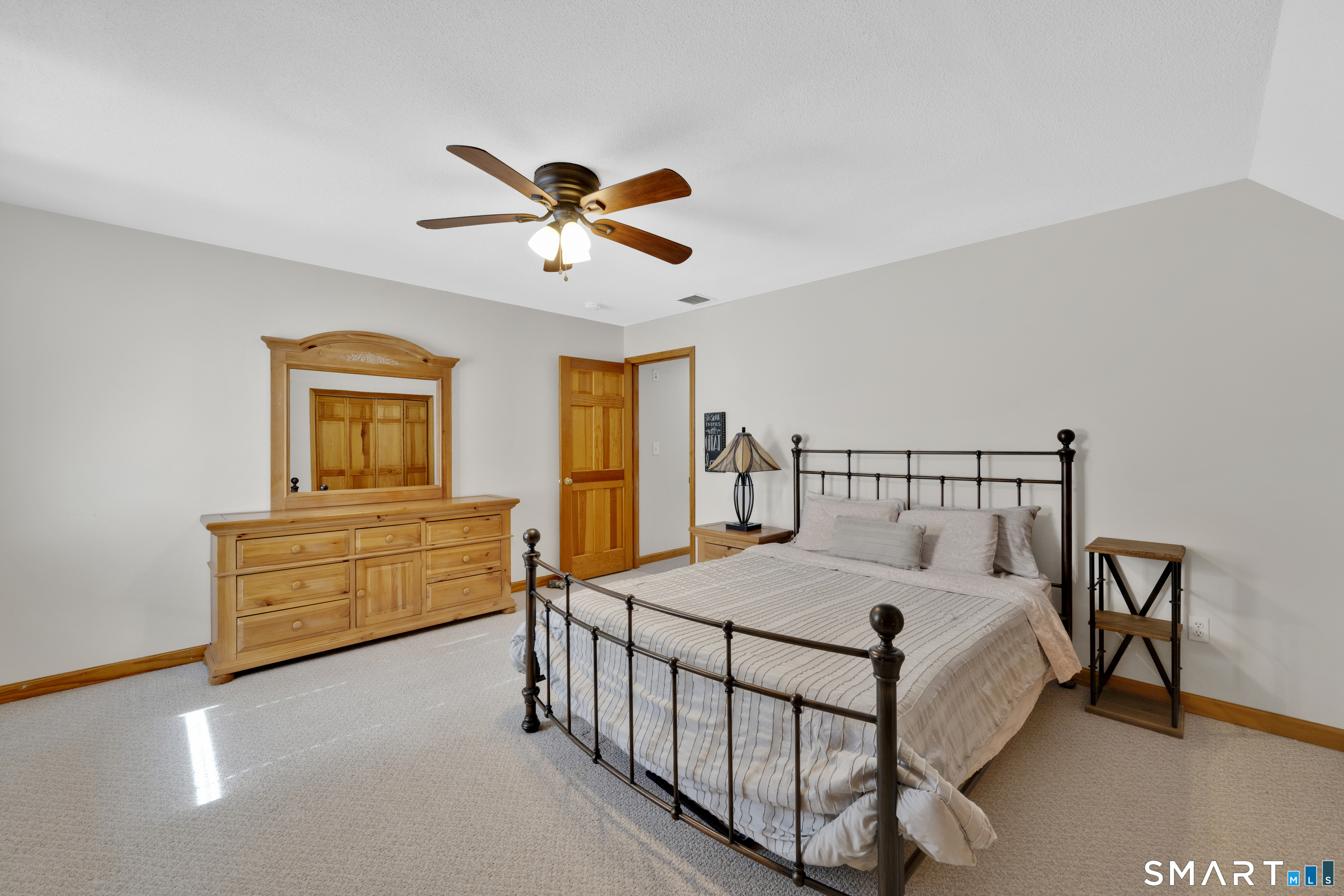 16 Higgins Way Tolland, CT 06084 - Photo 23 of 42 a bedroom with a bed and a chandelier
