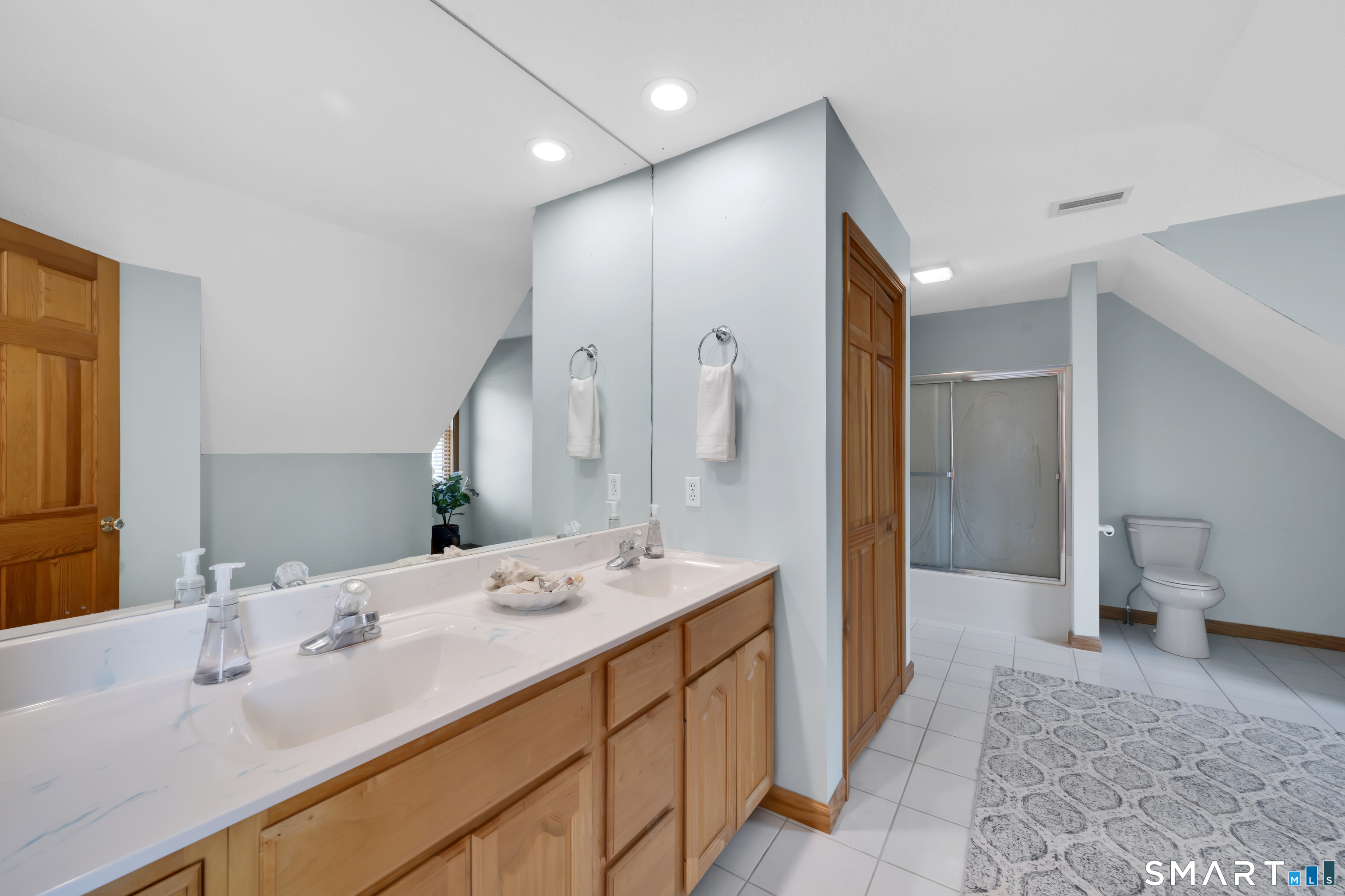 16 Higgins Way Tolland, CT 06084 - Photo 26 of 42 a en suite bathroom with a double vanity sink and a mirror