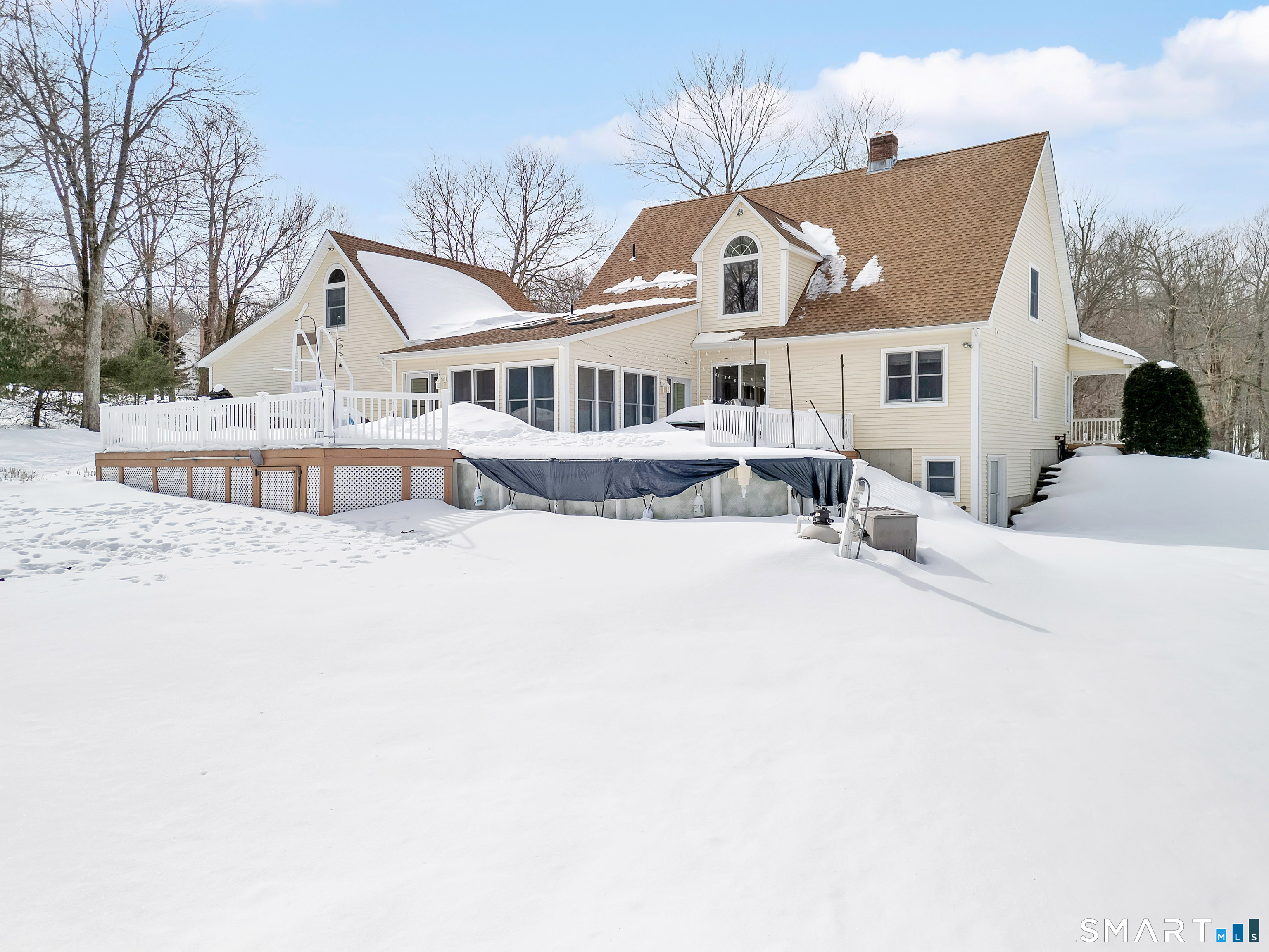 16 Higgins Way Tolland, CT 06084 - Photo 29 of 42 a front view of a house with a yard covered with snow in front of it
