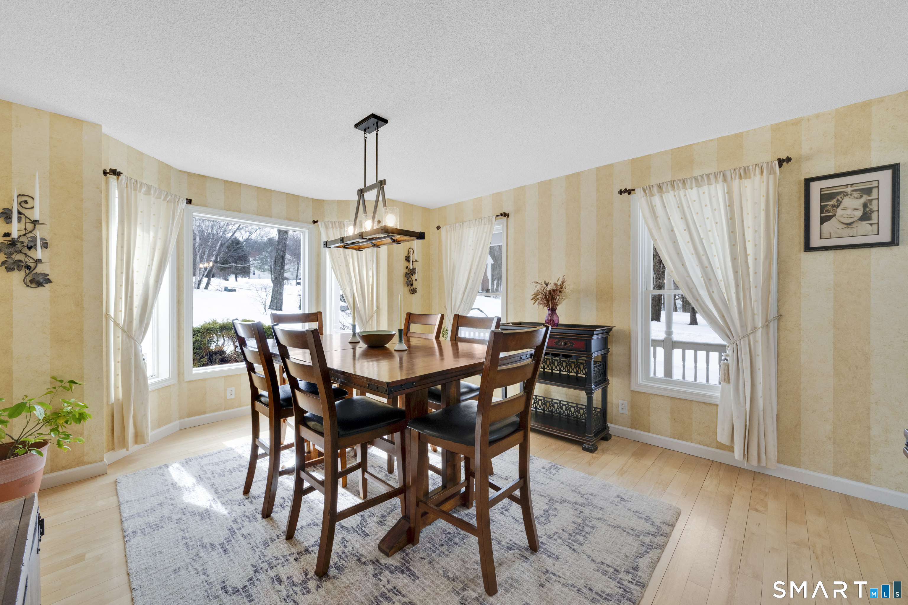 16 Higgins Way Tolland, CT 06084 - Photo 37 of 42 a view of a a dining room with furniture window and wooden floor