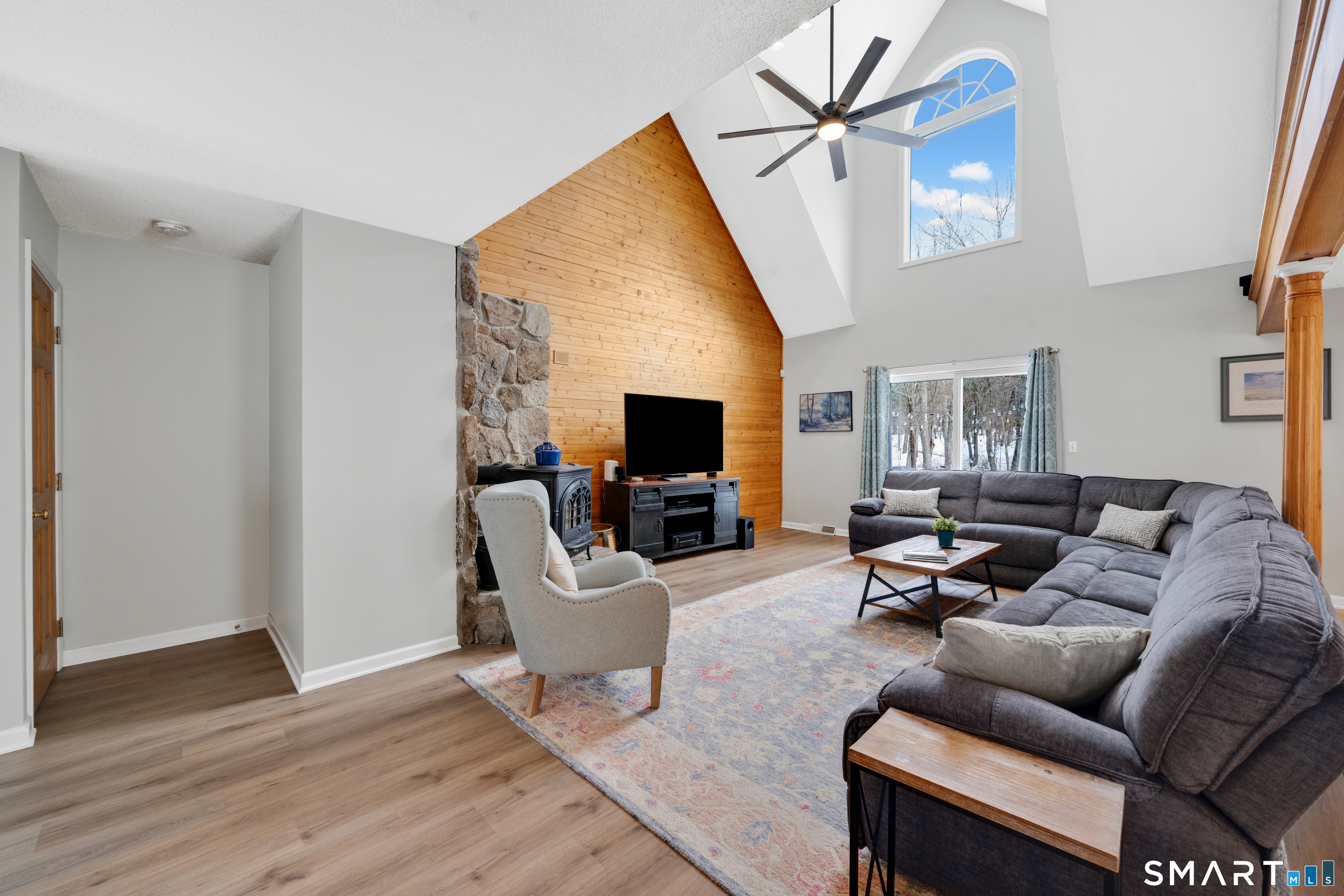 16 Higgins Way Tolland, CT 06084 - Photo 4 of 42 a living room with furniture a flat screen tv and a fireplace