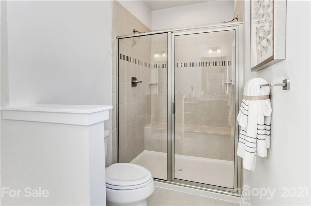 957 Portrush Lane, Unit 1010D Tega Cay, SC 29708 - Photo 8 of 13 a bathroom with a shower and a toilet