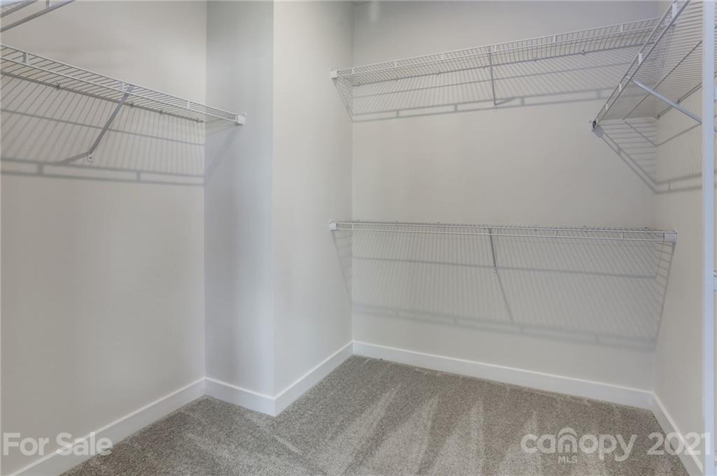 957 Portrush Lane, Unit 1010D Tega Cay, SC 29708 - Photo 10 of 13 a view of a room with racks on the wall
