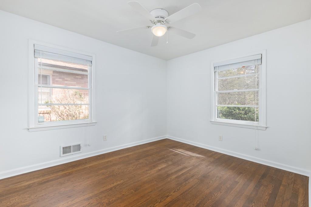 282 Willis Mill Road Southwest Atlanta, GA 30311 - Photo 15 of 25 a view of an empty room with wooden floor and a window