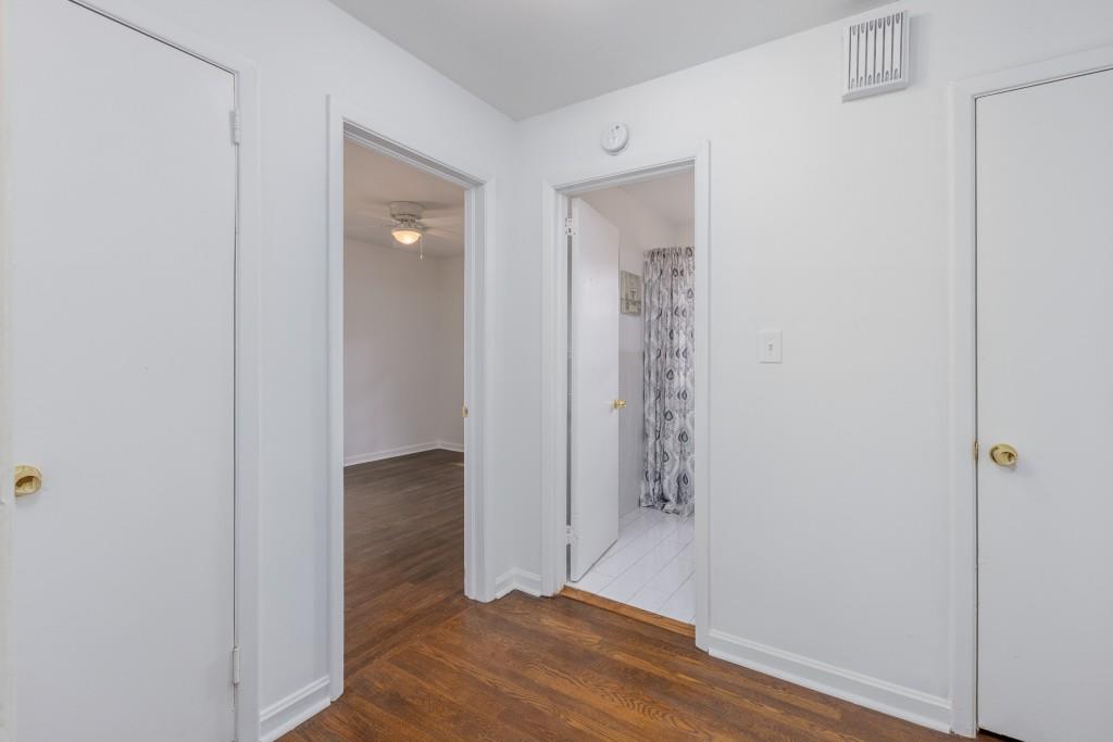282 Willis Mill Road Southwest Atlanta, GA 30311 - Photo 17 of 25 an empty room with wooden floor and entrance