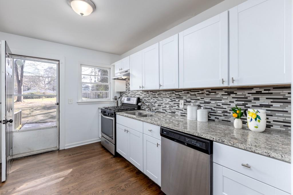 282 Willis Mill Road Southwest Atlanta, GA 30311 - Photo 9 of 25 a kitchen with stainless steel appliances granite countertop a sink a stove and window