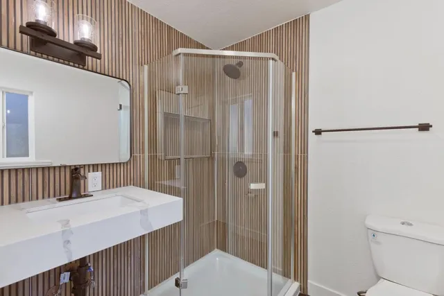 a bathroom with a shower and a toilet