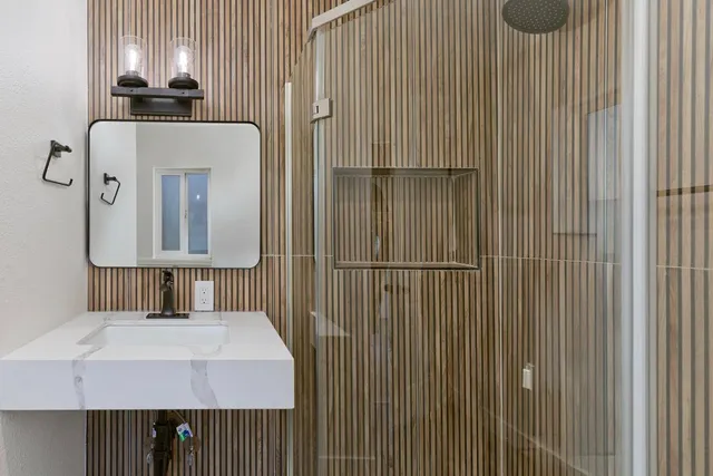 a bathroom with a sink vanity and a mirror