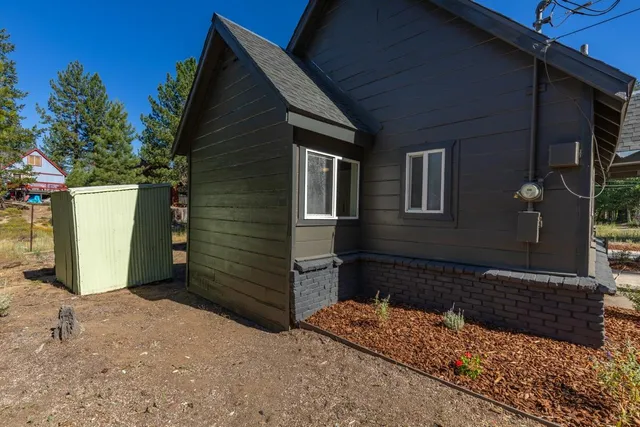 an aerial view of a house with a yard