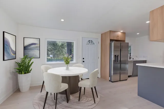 a view of a dining room with furniture and a potted plant