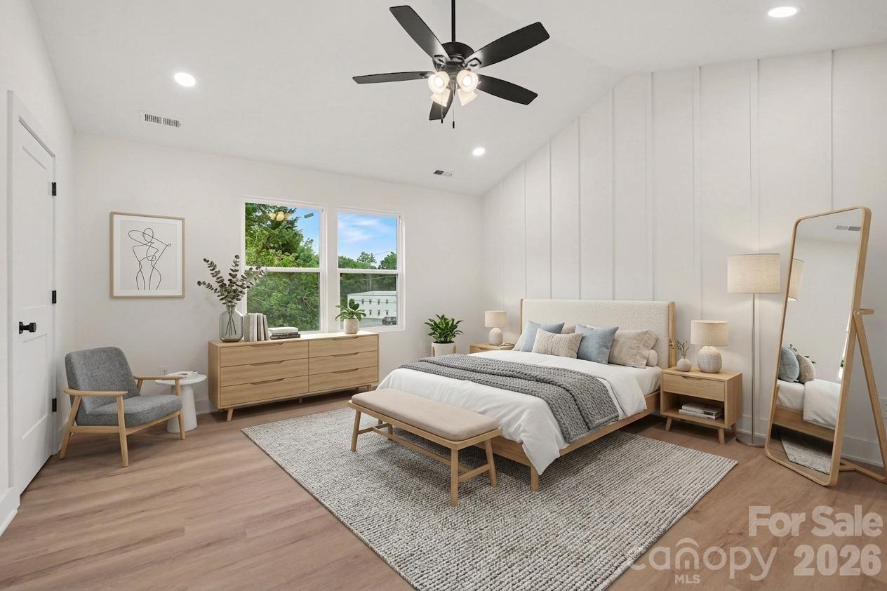 7521 Lawyers Road Charlotte, NC 28227 - Photo 6 of 35 a spacious bedroom with a bed and a couch