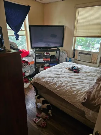 a bedroom with a bed and dresser