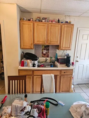 a close view of a sink and a bed in a kitchen