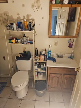 a bathroom with a toilet sink and mirror