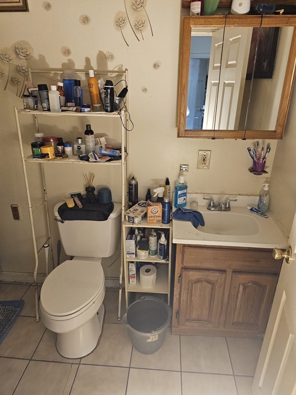 34 East Main Street, Unit 2 SOUTH Brockton, MA 02301 - Photo 10 of 14 a bathroom with a toilet sink and mirror