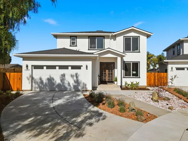 a front view of a house with a yard outdoor seating and barbeque oven