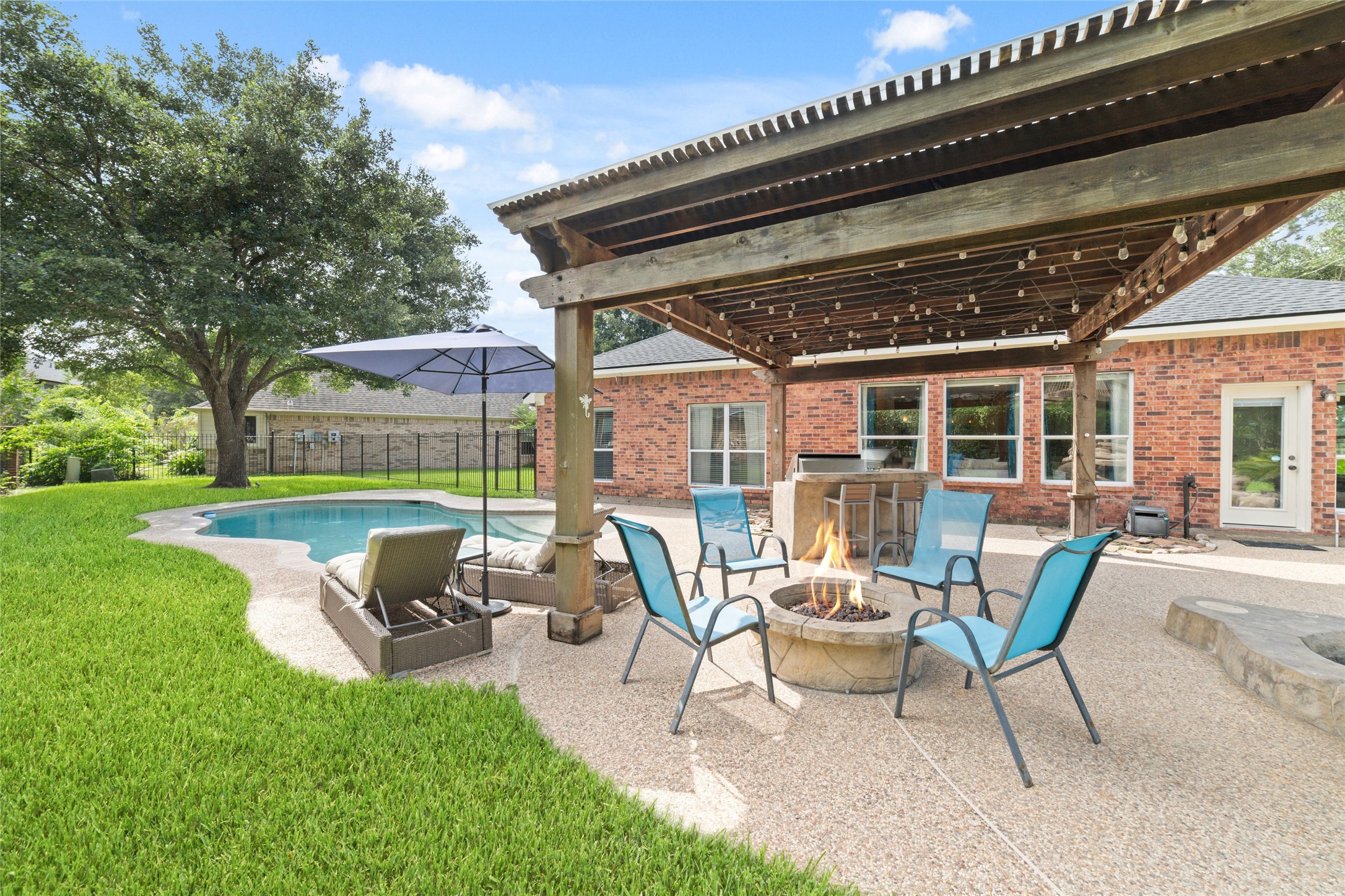 24203 Moon Ridge Court Katy, TX 77494 - Photo 36 of 43 Pergola-covered seating area, a fire pit, and a swimming pool. Perfect for relaxation and entertaining.