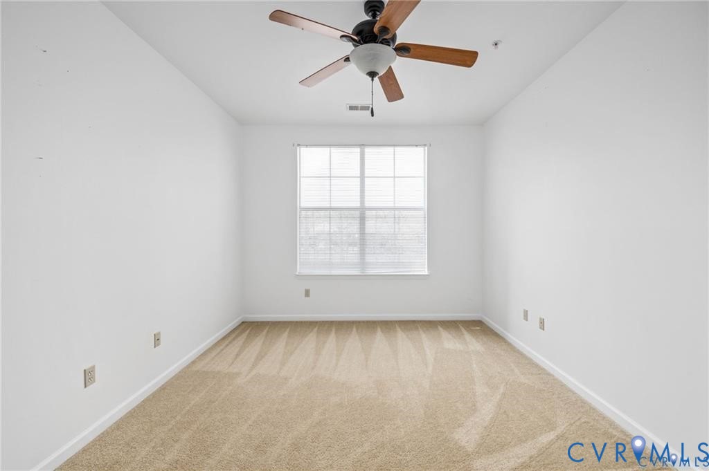 614 Bristol Village Drive, Unit 203 Midlothian, VA 23114 - Photo 25 of 32 an empty room with a window and a fan