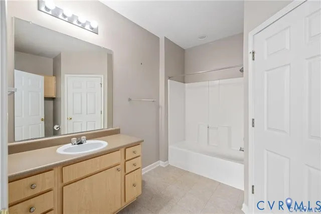 a bathroom with a shower sink and mirror