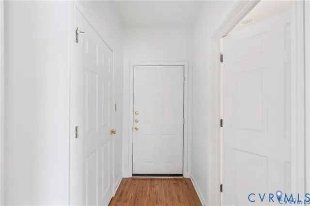 a view of a hallway with wooden floor