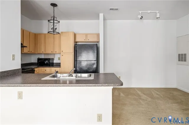 a kitchen with kitchen island a counter top space appliances and cabinets