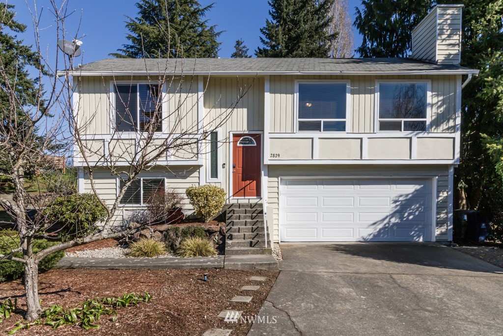 2829 Northeast 4th Court Renton, WA 98056 - Photo 1 of 26 a front view of a house with garden
