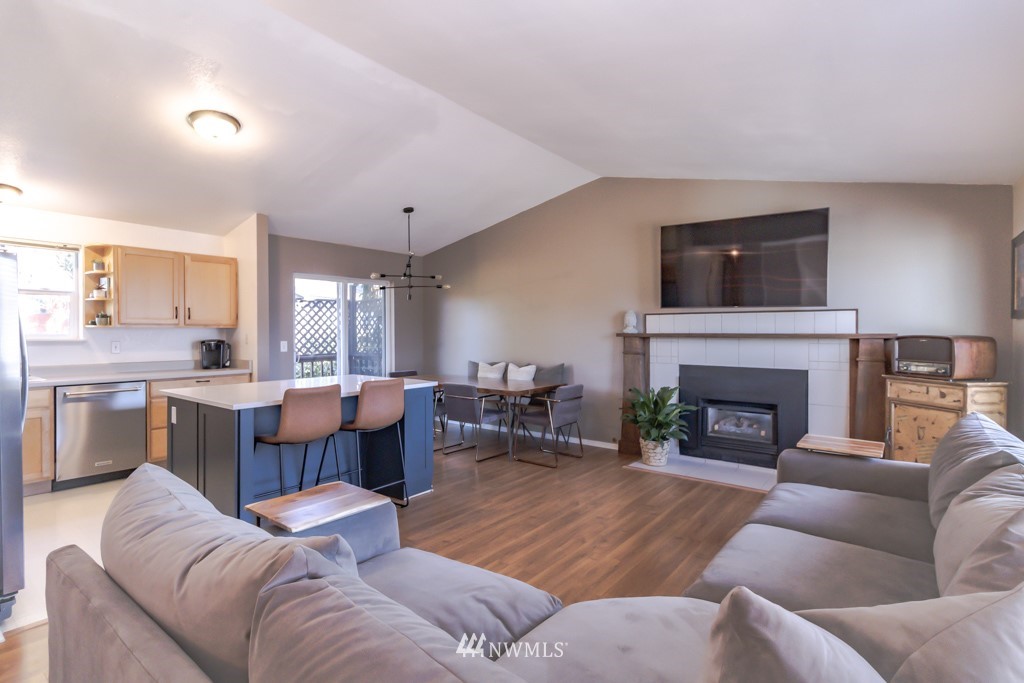 2829 Northeast 4th Court Renton, WA 98056 - Photo 8 of 26 a living room with furniture a fireplace and a flat screen tv