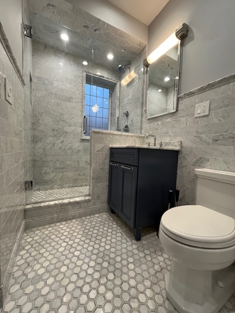 1372 East 57th Street, Unit 2 Chicago, IL 60637 - Photo 11 of 13 a bathroom with a sink a toilet and shower