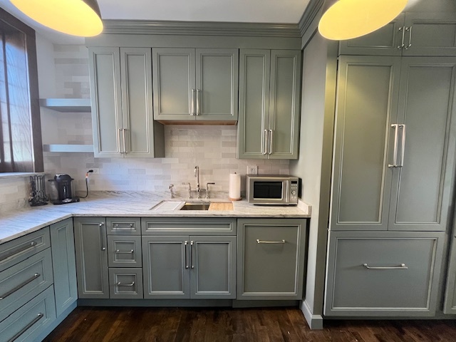 1372 East 57th Street, Unit 2 Chicago, IL 60637 - Photo 6 of 13 a kitchen with stainless steel appliances granite countertop a sink and cabinets with wooden floor