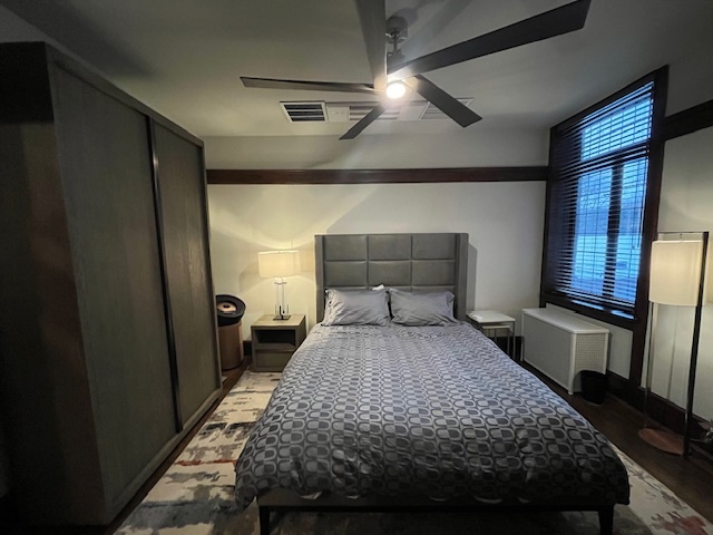 1372 East 57th Street, Unit 2 Chicago, IL 60637 - Photo 8 of 13 a bedroom with a bed and a mirror on a dresser