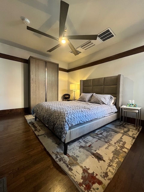 1372 East 57th Street, Unit 2 Chicago, IL 60637 - Photo 9 of 13 a bedroom with a bed and wooden floor