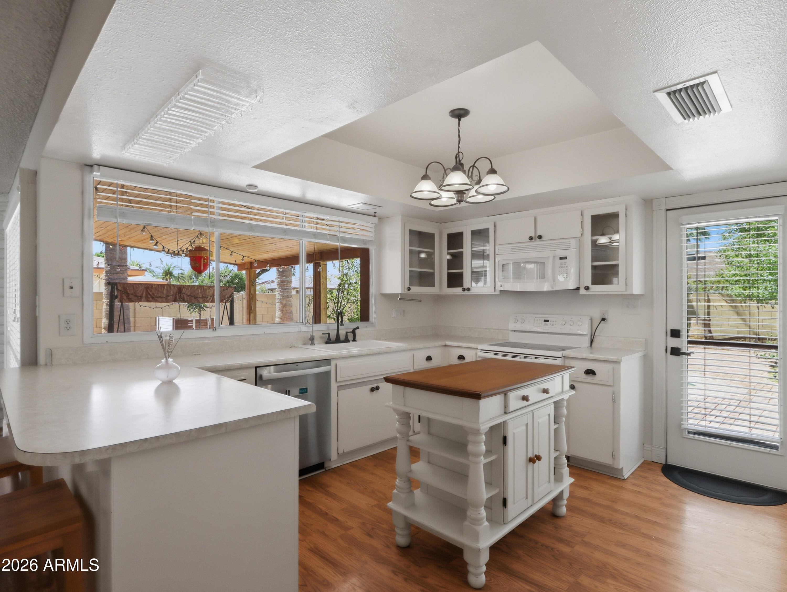 450 Cascada Road Litchfield Park, AZ 85340 - Photo 12 of 40 a kitchen with a sink stove and cabinets