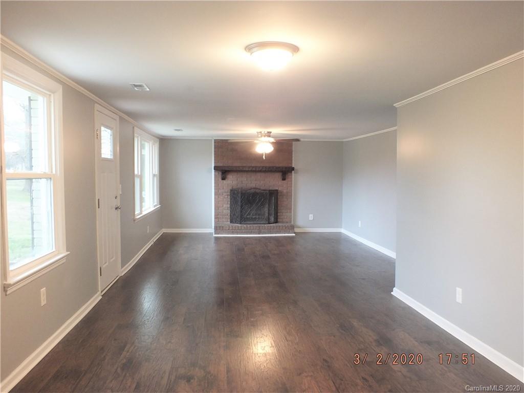 2035 Knight Road Lancaster, SC 29720 - Photo 2 of 26 an empty room with wooden floor and windows