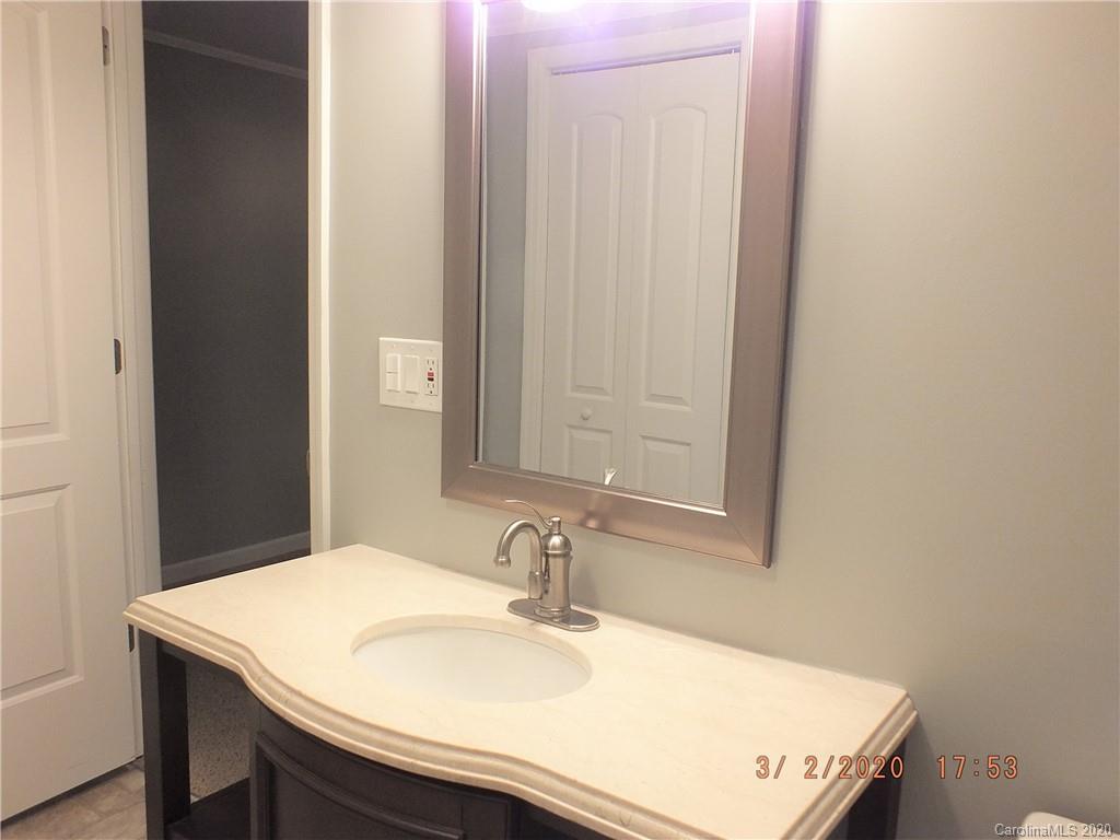 2035 Knight Road Lancaster, SC 29720 - Photo 13 of 26 a bathroom with a sink and a mirror