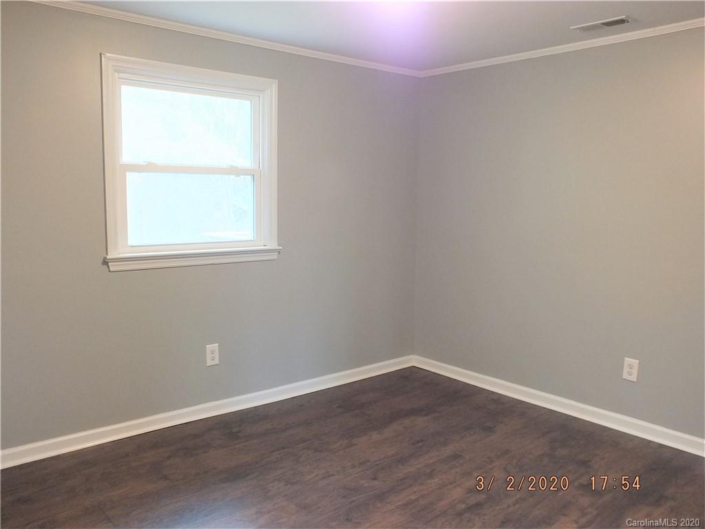 2035 Knight Road Lancaster, SC 29720 - Photo 16 of 26 an empty room with wooden floor and windows