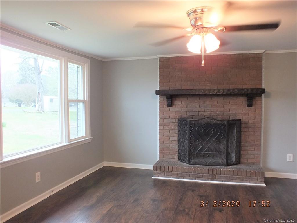 2035 Knight Road Lancaster, SC 29720 - Photo 3 of 26 a living room with a fireplace windows and a ceiling fan