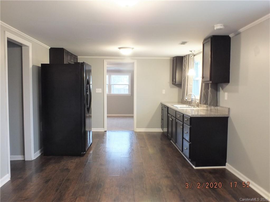 2035 Knight Road Lancaster, SC 29720 - Photo 4 of 26 a kitchen with a refrigerator and a sink