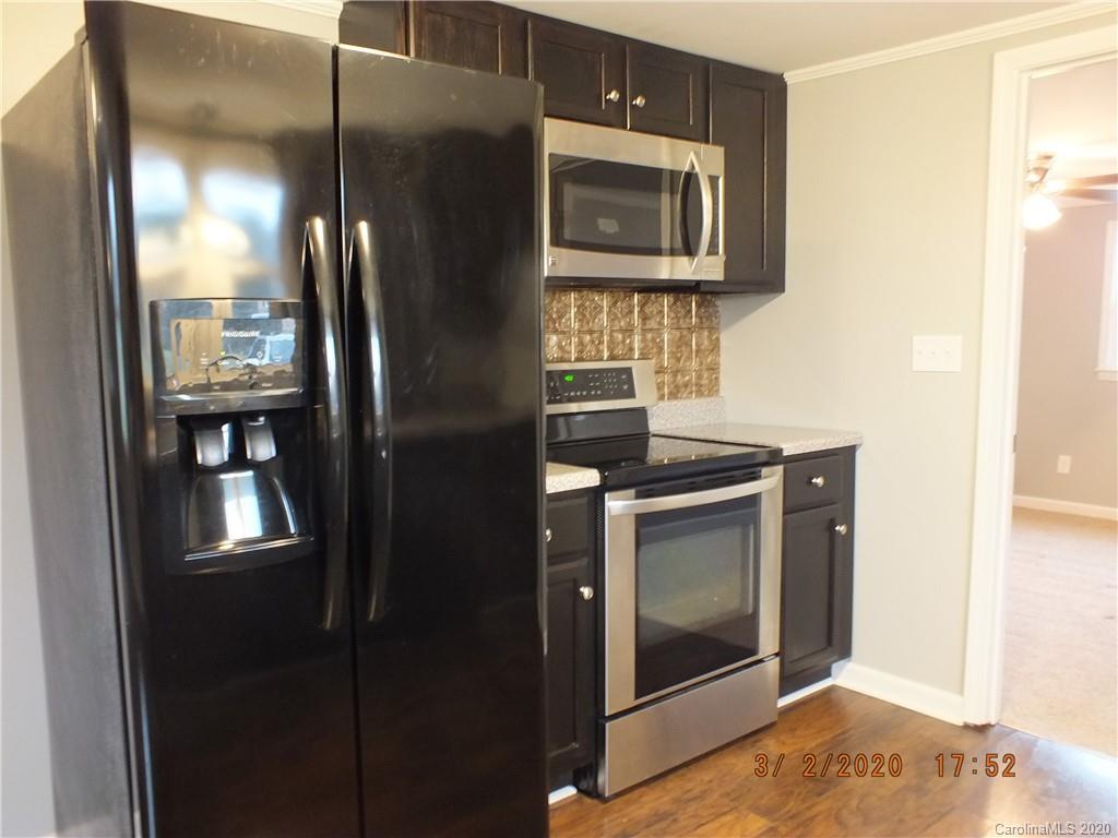 2035 Knight Road Lancaster, SC 29720 - Photo 6 of 26 a kitchen with granite countertop cabinets and stainless steel appliances