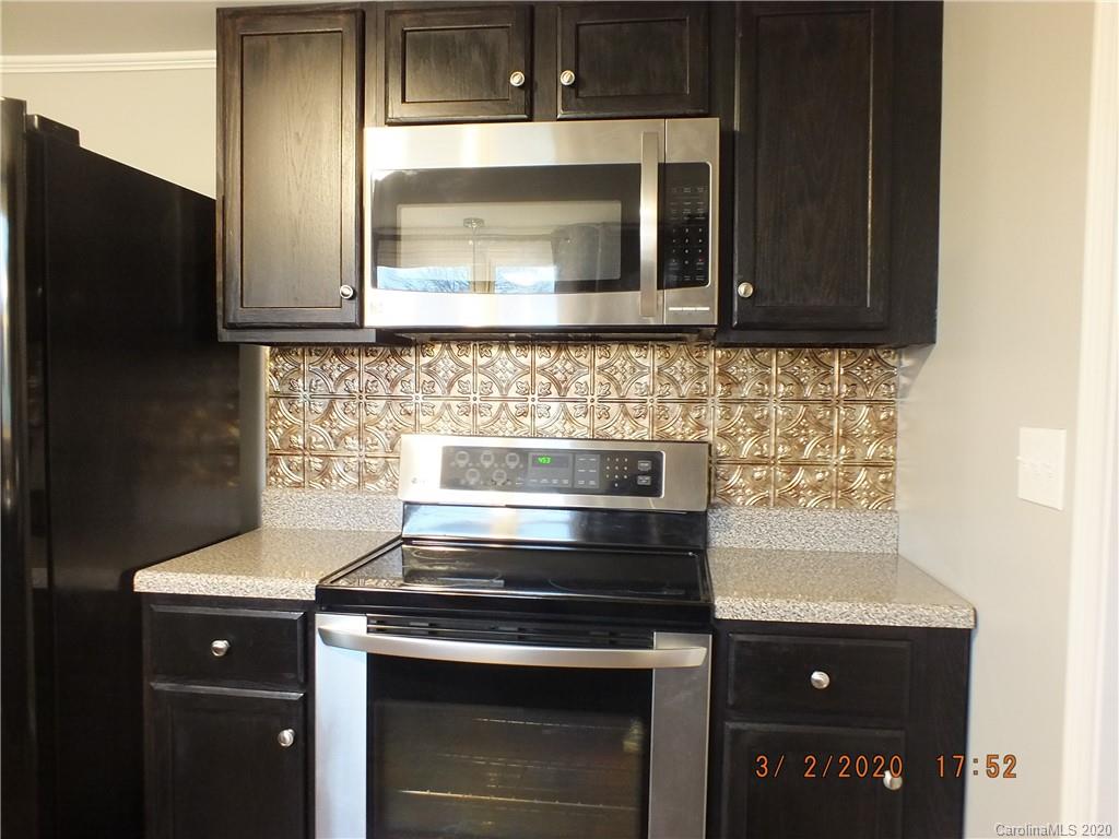 2035 Knight Road Lancaster, SC 29720 - Photo 7 of 26 a kitchen with stainless steel appliances granite countertop a stove and a microwave