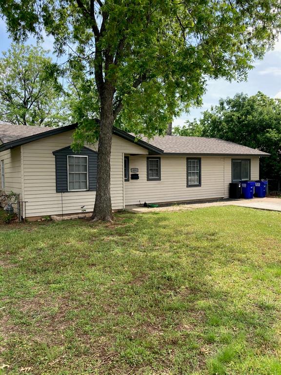 a front view of house with yard and trees